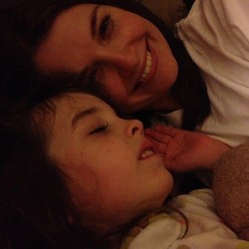 A mother and daughter nestled close together