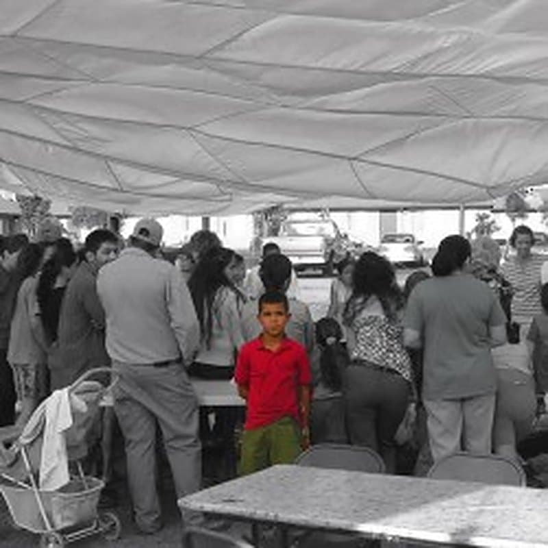 A crowd gathered together under a large tent