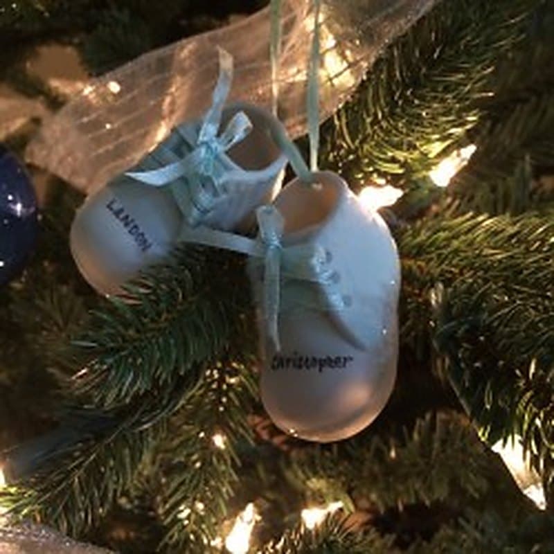 Baby-shoe keepsake ornaments hanging on a Christmas tree