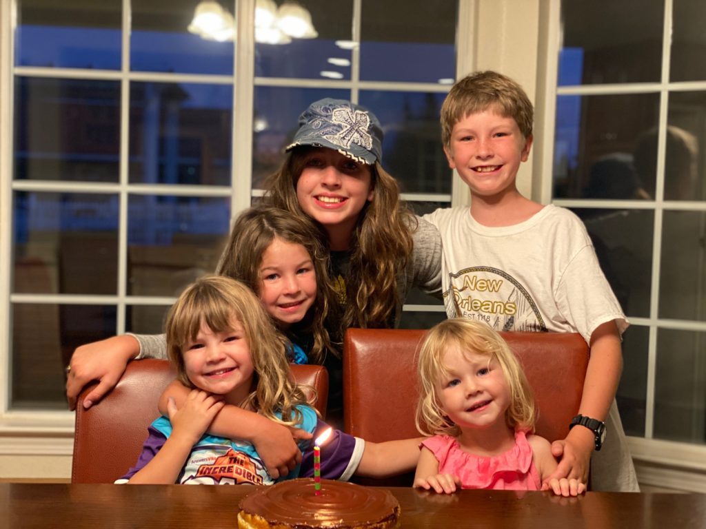 The Hopkins children gathered around a cake with a single candle for Ruth's first birthday